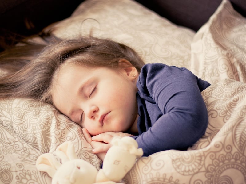 Sleeping child with teddy bear